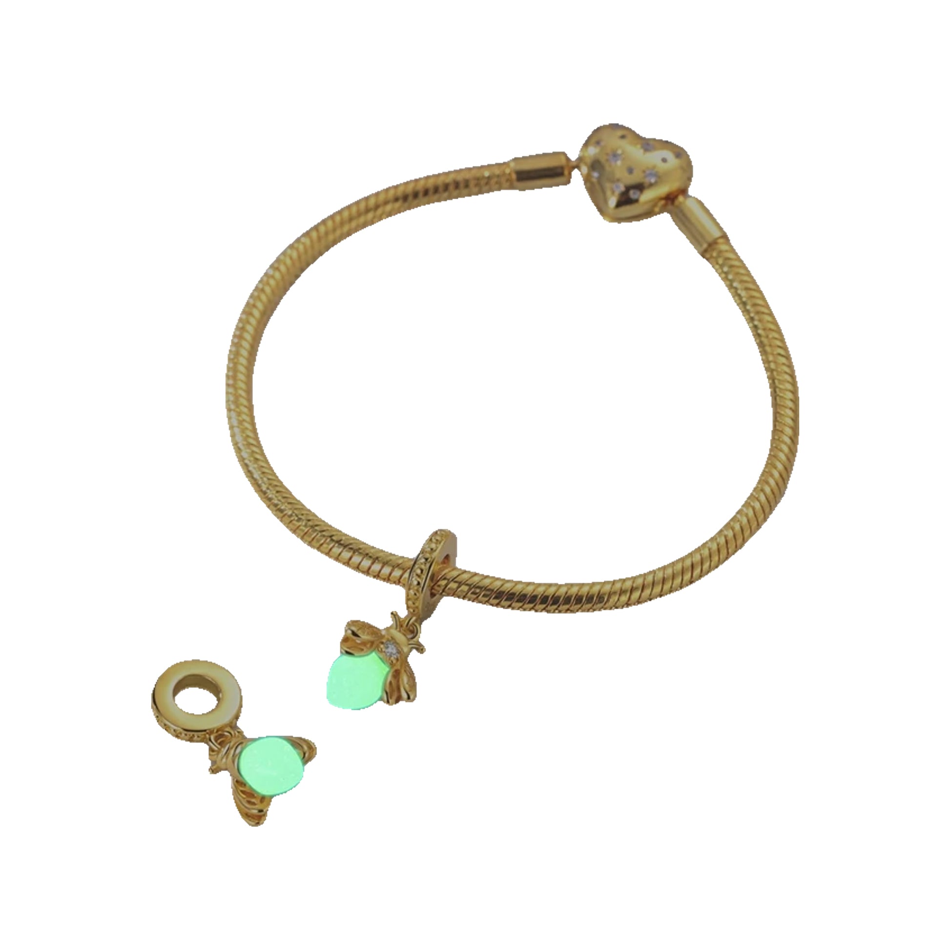 Gold-tone bracelet with bee charms and glow-in-the-dark stone accents displayed on a tabletop