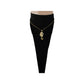 Gold-tone seahorse pendant necklace worn at the collarbone over a black top