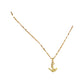 Gold-tone anchor pendant necklace worn at the collarbone