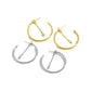 Two gold-tone and two silver-tone 25 mm hoops with marquise chain dangles arranged diagonally