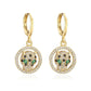 Gold-tone leopard head drop earrings set inside crystal-studded round frames on white background