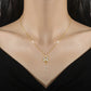 Gold-tone butterfly pendant with dangling accents worn at the collarbone