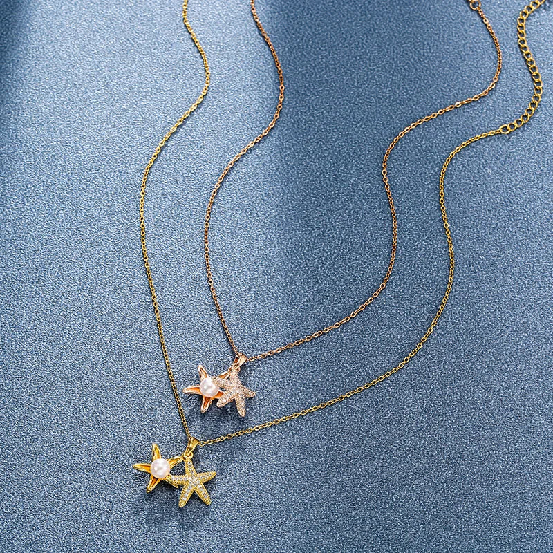 Two delicate chains, one gold-tone and one rose gold-tone, each with a starfish pendant; extenders are visible at the ends.