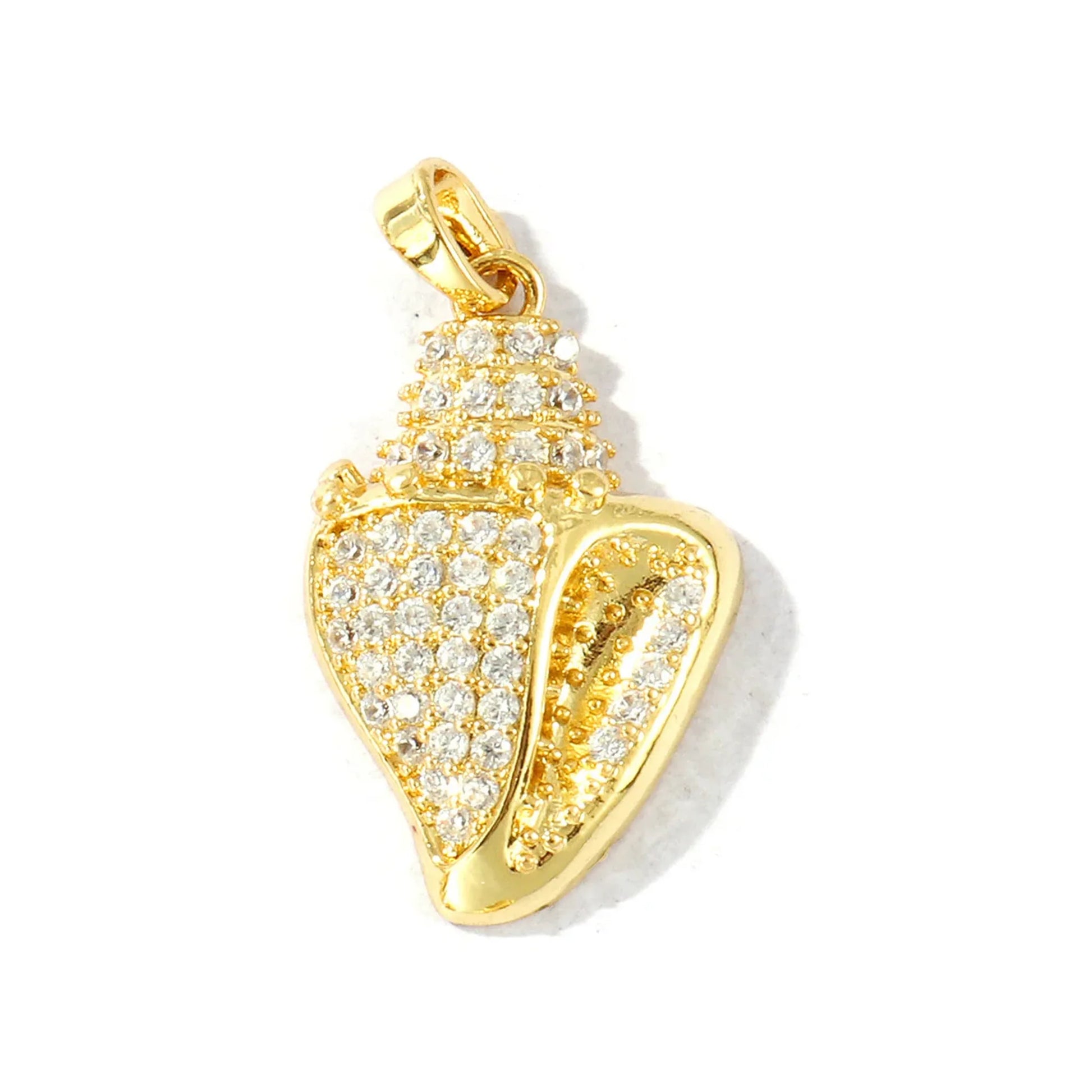 Gold-tone seashell charm densely set with rhinestones and a small open spiral detail