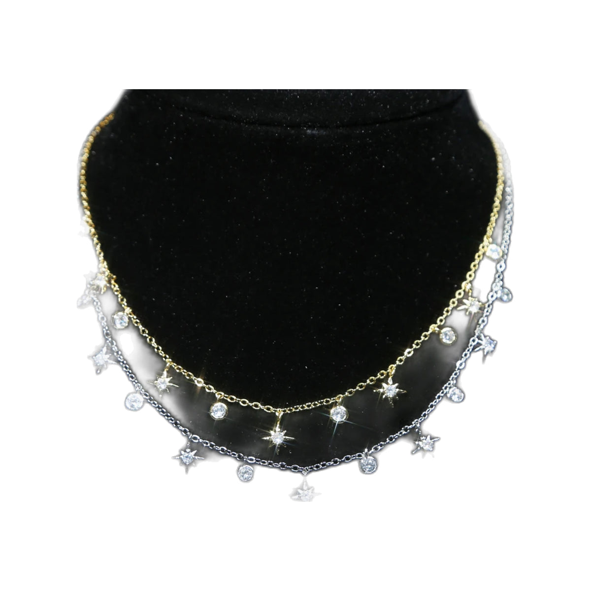 gold-tone and silver-tone Starburst dangle chokers layered on a black display