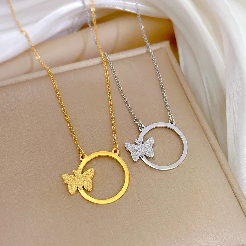 Gold-tone and silver-tone circle-and-butterfly pendant necklaces product view