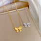 Gold-tone and silver-tone bow pendant necklaces paired on a soft display