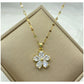 gold-tone flower pendant necklace with teardrop clear stone petals