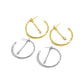 Two gold-tone and two silver-tone 25 mm hoops with marquise chain dangles on white background