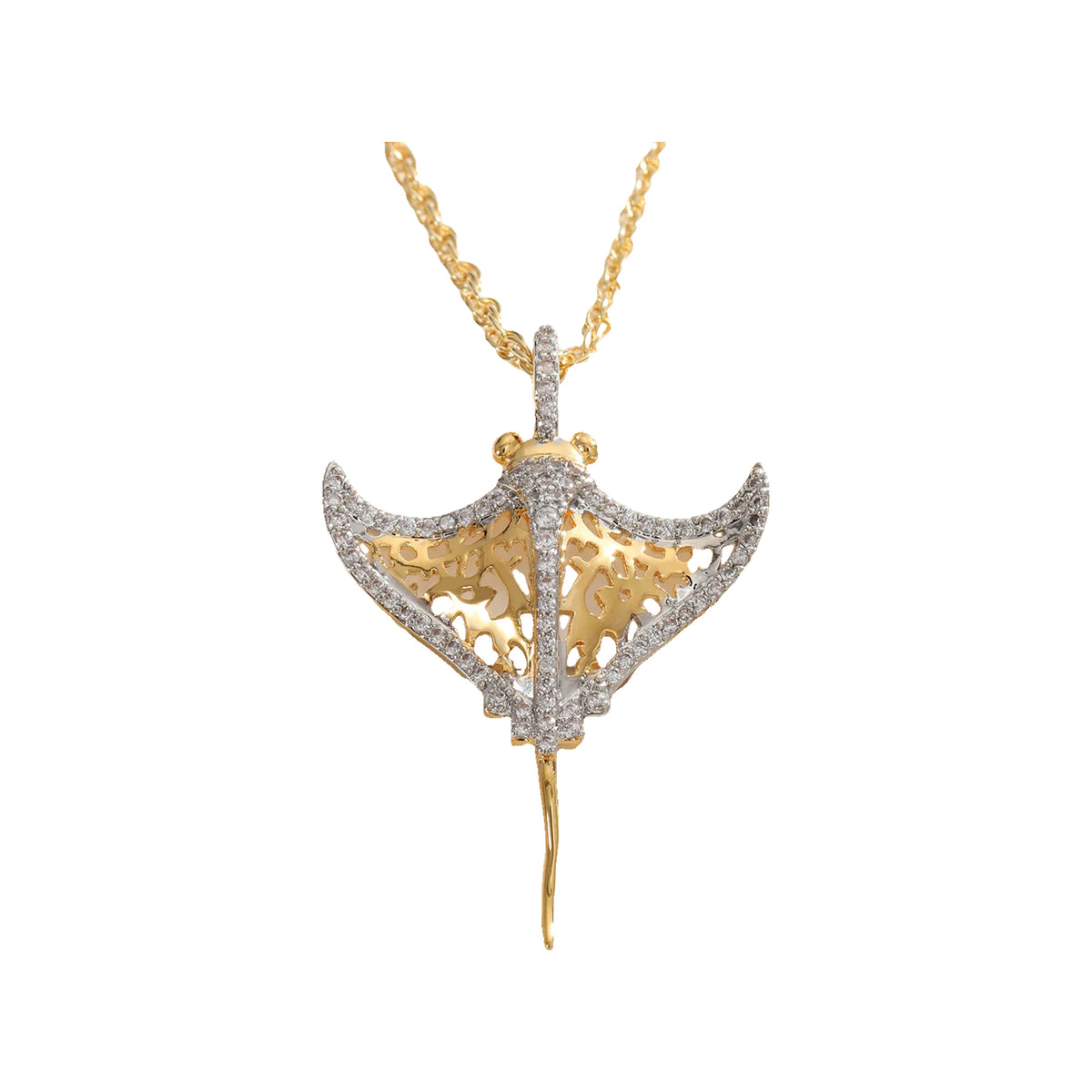 Close-up of two-tone manta ray pendant with silver-tone stone outline and gold-tone filigree on a rope chain