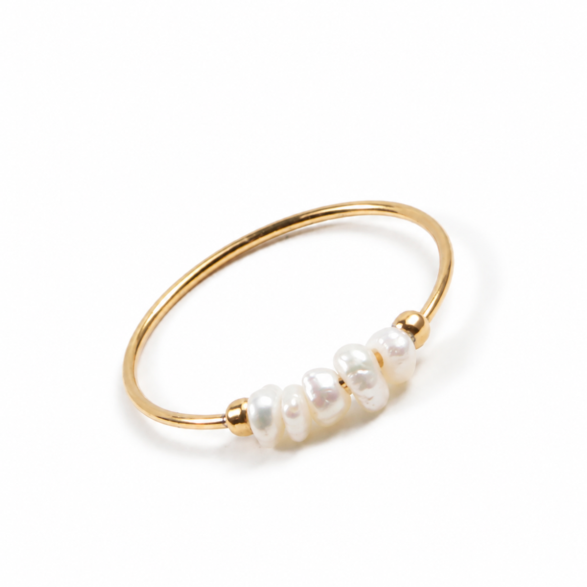 Gold-tone pearly bead stacking ring on white background