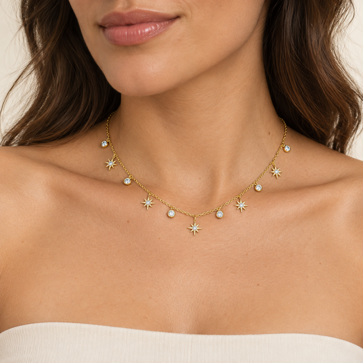 Olive skin model wearing gold-tone star and bezel charm choker necklace